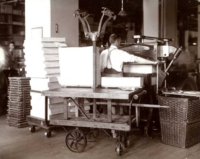 Man at a machine that cuts tablets at the J.C. Blair Company